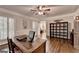Bright home office boasts hardwood floors, custom shutters, fan lighting, and neutral walls at 2230 Cammie Wages Rd, Dacula, GA 30019