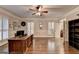 Bright home office boasts hardwood floors, custom shutters, fan lighting, and neutral walls at 2230 Cammie Wages Rd, Dacula, GA 30019
