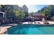 Open-air patio features a large in-ground pool, a gazebo, lounge chairs, and well-manicured palm trees at 2230 Cammie Wages Rd, Dacula, GA 30019