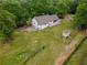 Aerial view of the home showcasing the spacious lot and exterior features, including a shed and back deck at 3241 Briscoe Rd, Loganville, GA 30052