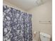 Cozy bathroom with patterned blue shower curtain, silver towel rack, toilet, and tile floor at 3241 Briscoe Rd, Loganville, GA 30052