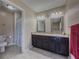 Bathroom featuring a double sink vanity, tile floors, and a shower with curtain at 3241 Briscoe Rd, Loganville, GA 30052