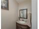 Traditional half bathroom featuring an oval sink, framed mirror, and neutral wall paint at 3241 Briscoe Rd, Loganville, GA 30052