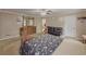 Bright bedroom featuring a large wooden bed, dresser, and access to an ensuite bathroom at 3241 Briscoe Rd, Loganville, GA 30052