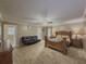 Spacious bedroom with a ceiling fan, complemented by a leather futon and natural light at 3241 Briscoe Rd, Loganville, GA 30052