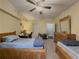 Spacious bedroom with ceiling fan, natural light, and carpet at 3241 Briscoe Rd, Loganville, GA 30052