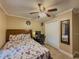 Cozy bedroom with closet, fan, desk, and patterned bedding at 3241 Briscoe Rd, Loganville, GA 30052