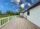 Back deck of the home with white railings and a porch swing at 3241 Briscoe Rd, Loganville, GA 30052