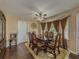 Dining room with a wood table, upholstered chairs, wood flooring, and natural light at 3241 Briscoe Rd, Loganville, GA 30052