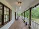 Cozy front porch with seating, potted plants, and a serene view of the surrounding landscape at 3241 Briscoe Rd, Loganville, GA 30052