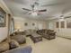 Large living room with multiple seating areas, ceiling fans, and lots of natural light at 3241 Briscoe Rd, Loganville, GA 30052