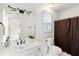 Bright bathroom with white vanity, framed mirror, and neutral-colored shower curtain at 790 Thornberry Dr, Alpharetta, GA 30022