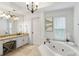 Well-lit bathroom with a soaking tub, granite countertops, and a vanity area, providing a spa-like experience at 790 Thornberry Dr, Alpharetta, GA 30022