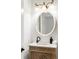 Chic bathroom with a decorative vanity, unique lighting fixture, oval mirror, and modern fixtures at 790 Thornberry Dr, Alpharetta, GA 30022