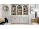 Arched built-in shelving with decorative items and storage cabinets for a stylish and organized living space at 790 Thornberry Dr, Alpharetta, GA 30022