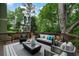 Relaxing outdoor deck featuring stylish seating, modern decor, and a serene wooded view at 790 Thornberry Dr, Alpharetta, GA 30022