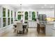 Dining room area featuring natural light from windows, modern light fixture and breakfast bar seating at 790 Thornberry Dr, Alpharetta, GA 30022