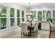 Open concept dining area with wine storage and large windows with views of outdoor deck at 790 Thornberry Dr, Alpharetta, GA 30022