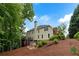 Charming home exterior with well-manicured landscaping, a cozy deck, and a backdrop of lush greenery at 790 Thornberry Dr, Alpharetta, GA 30022