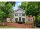 Stately brick home featuring classic architecture, arched entry, dark shutters, and mature landscaping at 790 Thornberry Dr, Alpharetta, GA 30022