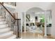 Foyer features staircase and views to the open concept dining and living rooms at 790 Thornberry Dr, Alpharetta, GA 30022