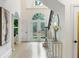 Bright foyer showcases arched doorway, hardwood floors, double glass doors and staircase at 790 Thornberry Dr, Alpharetta, GA 30022