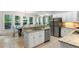 Bright kitchen featuring white cabinetry, stainless steel appliances, granite countertops, and a sunlit breakfast nook at 790 Thornberry Dr, Alpharetta, GA 30022