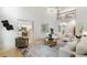 Open-concept living room with view to kitchen featuring hardwood floors and lots of natural light at 790 Thornberry Dr, Alpharetta, GA 30022