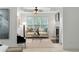 Bright living room with large windows, neutral decor, and a cozy fireplace for relaxing or entertaining guests at 790 Thornberry Dr, Alpharetta, GA 30022