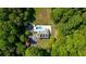 An aerial view featuring the house with a private pool surrounded by trees at 143 Navajo Trl, Rydal, GA 30171