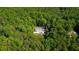 Aerial view of house featuring a private pool oasis surrounded by a lush forest at 143 Navajo Trl, Rydal, GA 30171