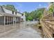 Spacious backyard featuring an inground pool, screen porch, and mature tree line at 143 Navajo Trl, Rydal, GA 30171