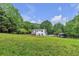 Estate backyard with mature trees plus a pool and outdoor recreation area for the whole Gathering at 143 Navajo Trl, Rydal, GA 30171