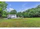 This country estate features a sprawling backyard, a well-manicured lawn, and a sparkling in-ground pool at 143 Navajo Trl, Rydal, GA 30171