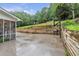 Expansive backyard patio features a grill, half-court basketball, playset and wooded surroundings at 143 Navajo Trl, Rydal, GA 30171