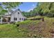 This home features a garden plot, an expansive backyard, and a lovely screened-in back porch at 143 Navajo Trl, Rydal, GA 30171