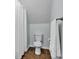 Simple bathroom with a white toilet, shower with curtain, and towel rack at 143 Navajo Trl, Rydal, GA 30171