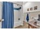 Elegant bathroom with blue accents and white paneling at 143 Navajo Trl, Rydal, GA 30171