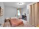 Light filled bedroom with a pink comforter, desk, and sheer curtains at 143 Navajo Trl, Rydal, GA 30171