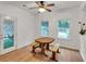 Bright dining room featuring a wooden table with bench seating and natural light from windows at 143 Navajo Trl, Rydal, GA 30171