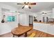 Dining room with wood floors, ceiling fan, and open access to the kitchen at 143 Navajo Trl, Rydal, GA 30171