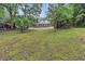 Exterior view of charming home featuring a sprawling front porch surrounded by mature trees at 143 Navajo Trl, Rydal, GA 30171