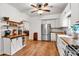 Bright kitchen featuring white cabinets, stainless steel appliances, wood counters and floors at 143 Navajo Trl, Rydal, GA 30171