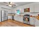 Bright kitchen featuring white cabinets, stainless steel appliances, wood counters and floors at 143 Navajo Trl, Rydal, GA 30171