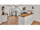 Bright kitchen featuring white cabinets, stainless steel appliances, wood counters and floors at 143 Navajo Trl, Rydal, GA 30171