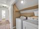 Bright laundry room featuring a washer, dryer, and overhead storage shelf at 143 Navajo Trl, Rydal, GA 30171