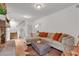 Bright living room with hardwood floors, fireplace, and staircase at 143 Navajo Trl, Rydal, GA 30171