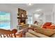 Cozy living room with a stone fireplace and views of the pool at 143 Navajo Trl, Rydal, GA 30171