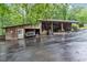A functional outbuilding on a large lot provides ample storage for vehicles, equipment, and recreational toys at 143 Navajo Trl, Rydal, GA 30171