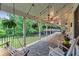 Inviting covered porch with wood floors, rocking chairs, hanging ferns and string lights at 143 Navajo Trl, Rydal, GA 30171